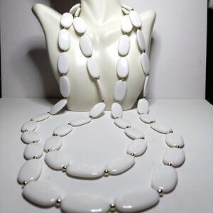 White oval beads with silvertone spacers 60"